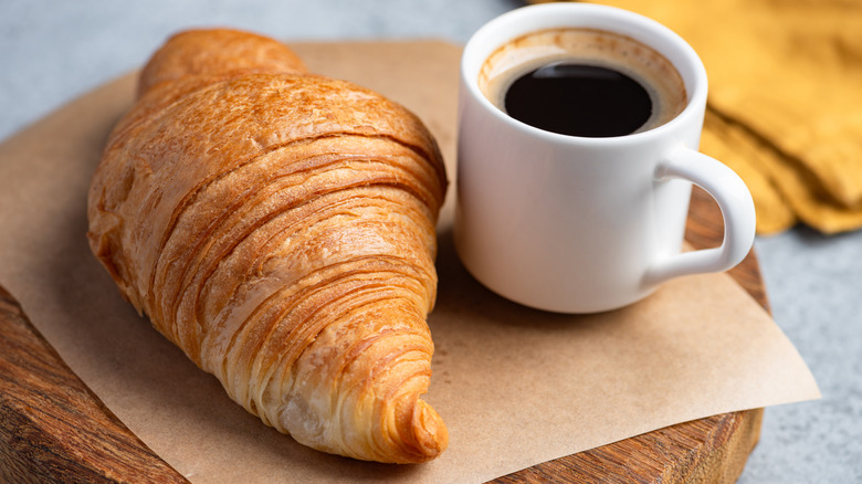 Cup of espresso and a croissant