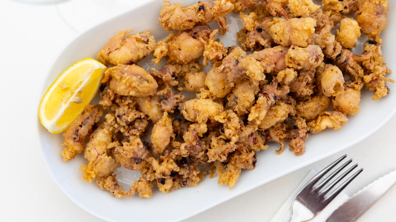 Fritto misto on a plate with a lemon wedge