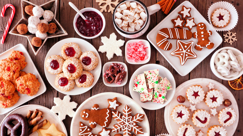 Table filled with dozens of holiday cookies and treats