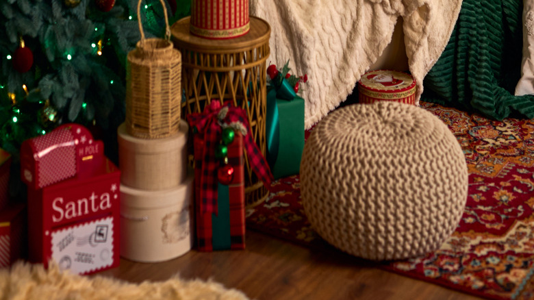 Cozy sofa next to a Christmas tree and holiday decorations