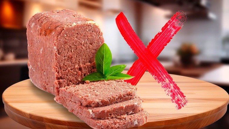 Sliced canned corned beef next to red X