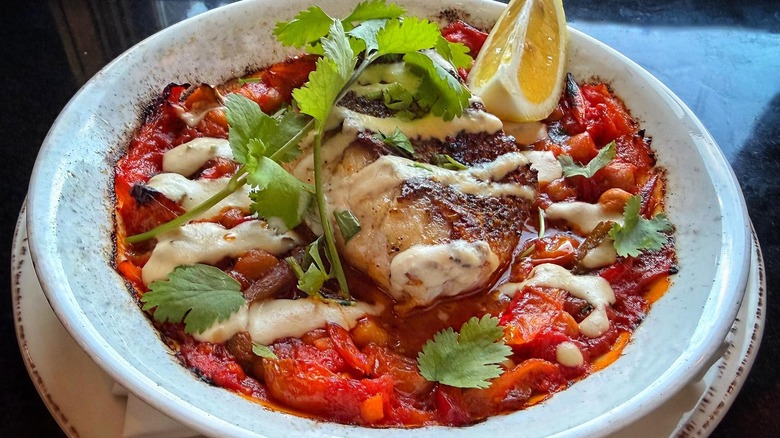 Pan-seared grouper on stewed vegetables in white bowl at Silver Star Cafe in Park City