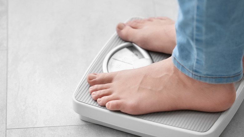 Close up of feet on a scale