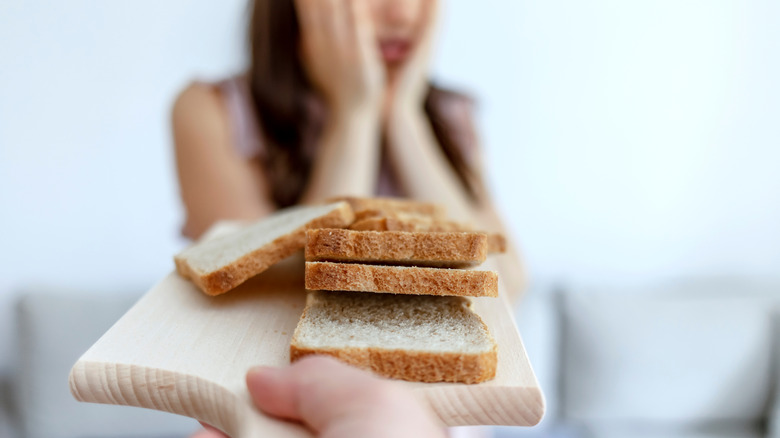 Woman reacting negativly to gluten free food
