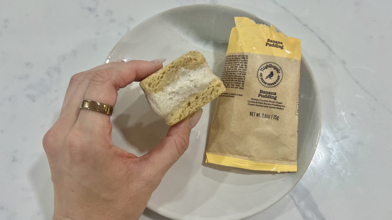 Hand holding chomps size Banana Pudding Nightingale ice cream sandwich.