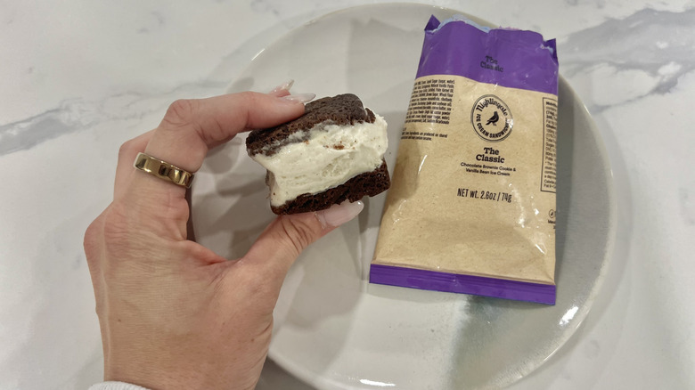 Hand holding chomps size The Classic Nightingale ice cream sandwich.