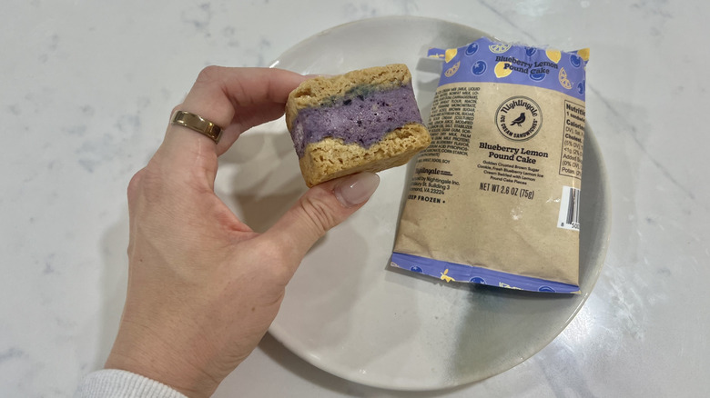 Hand holding chomps size Blueberry Lemon Pound Cake Nightingale ice cream sandwich.