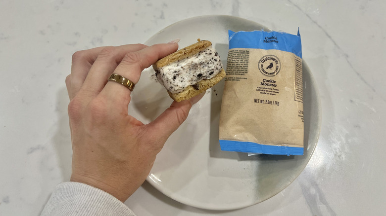 Hand holding chomps size Cookie Monster Nightingale ice cream sandwich.