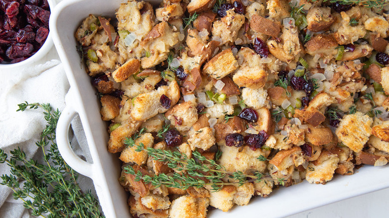 Country bread stuffing with dried cranberries in white baking dish