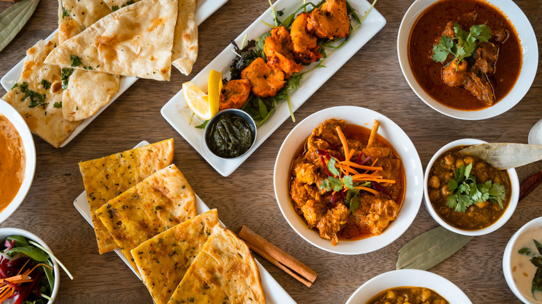 A table full of a variety of Indian dishes.