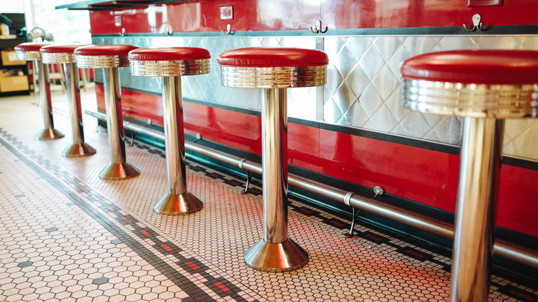 Red stools at retro soda fountain counter