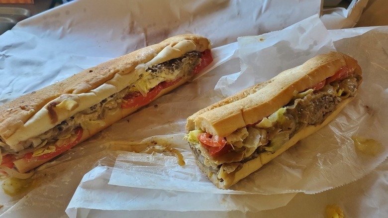 Two sub sandwiches loaded with ingredients