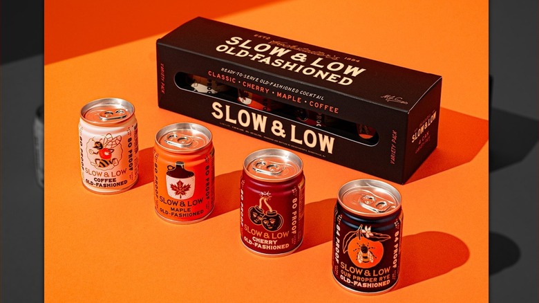 Slow & Low's collection of old fashioned cans lined up with the product box behind.