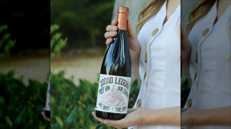 hands holding wine bottle