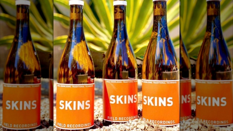 three bottles of orange wine