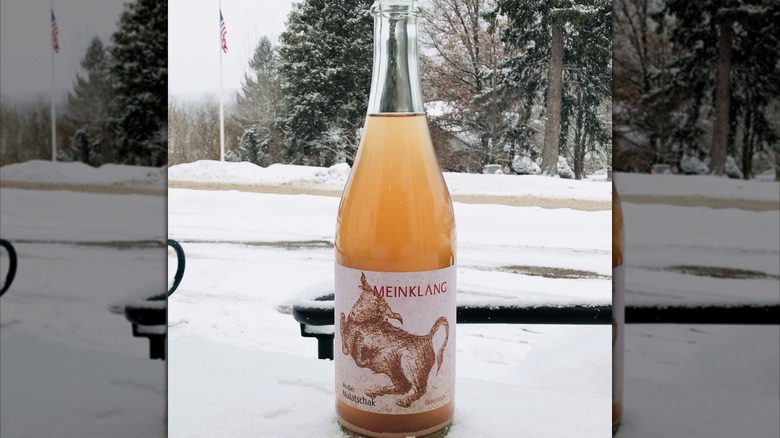 bottle of orange wine with snowy background
