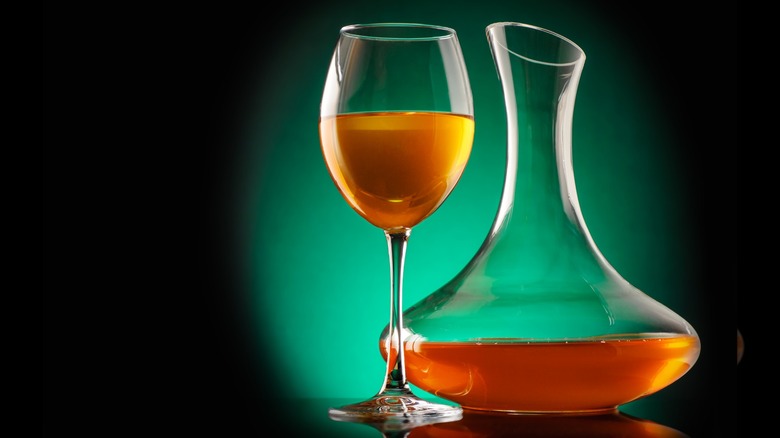 orange wine in glass and decanter