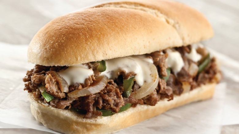 a Philly-style cheesesteak sandwich on a roll