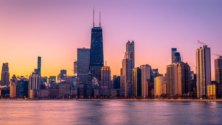 A purple-hued photo of the Chicago city skyline at dusk.