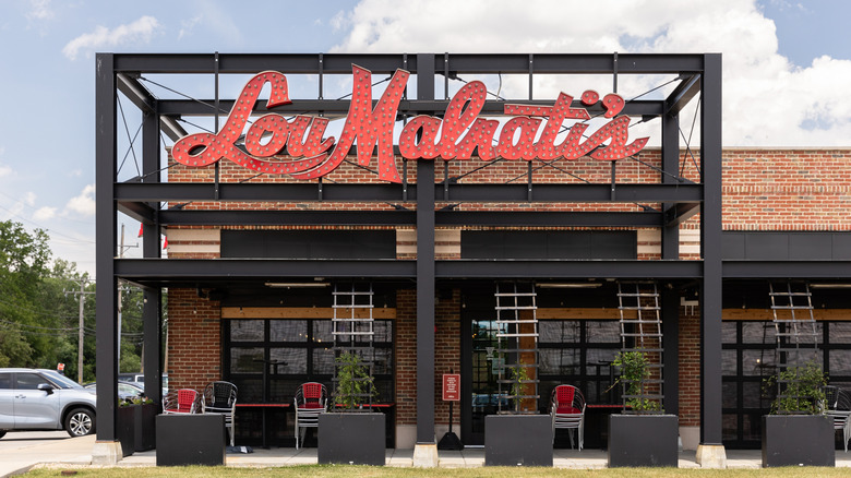 The exterior of a Lou Malnati's pizzeria with a red marquee.