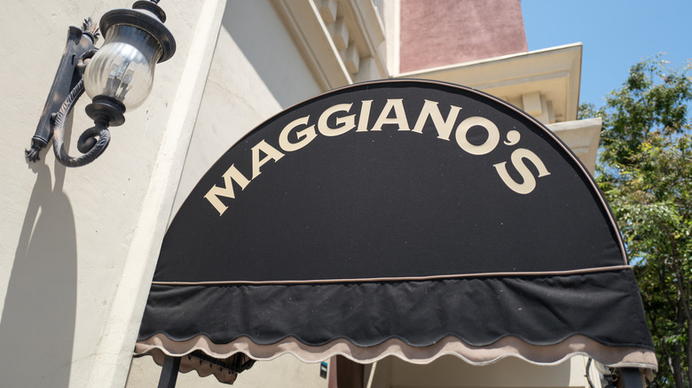 The awning of a Maggiano's Little Italy restaurant with the restaurant name in white lettering on a black background.