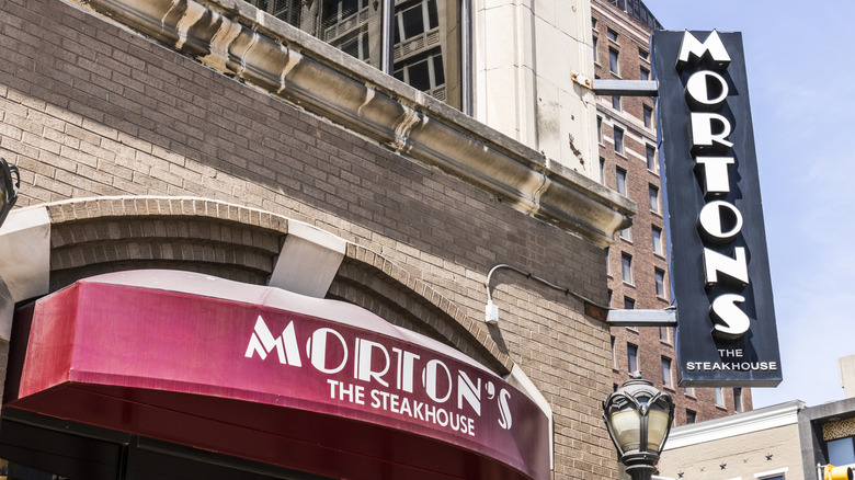 The black and white sign and red awning of a Morton's steakhouse.