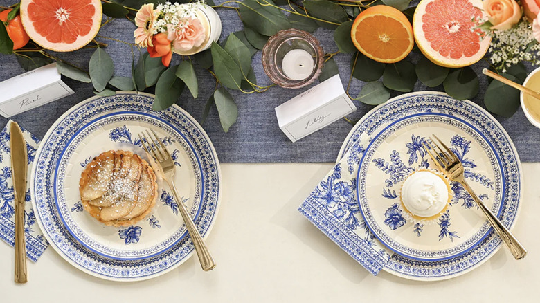 A styled tablescape featuring Coterie's Toile of My Love Paper Plates set