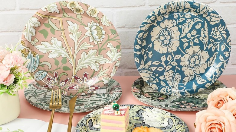 Vintage Wildfloral Paper Plates staged on a pink table, some standing upright