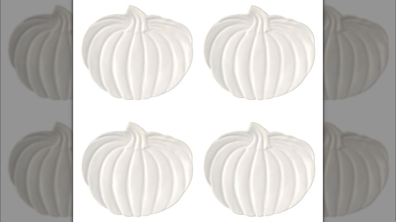Four small, all-white, pumpkin-shaped plates