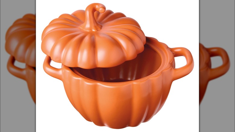 A large orange pumpkin-shaped dish with a lid