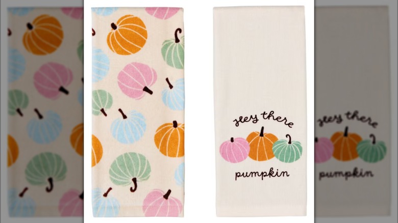 Two kitchen towels side by side with colorful pumpkin print