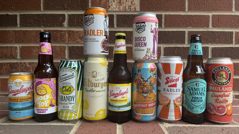 11 radlers and shandies from different brands lined up on brick surface
