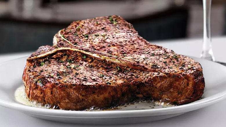 A white plate with a 24-ounce USDA prime T-bone steak