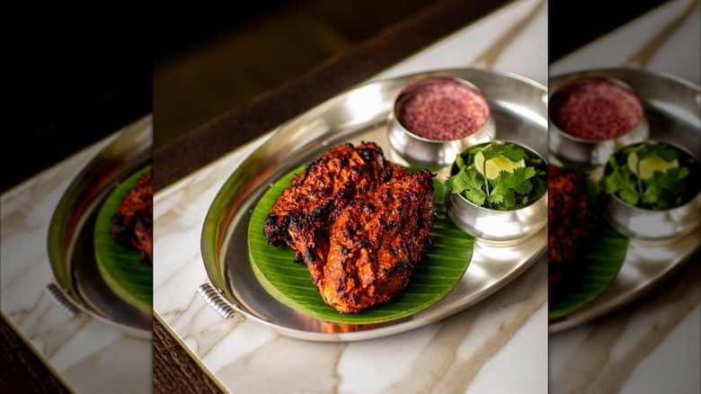 Tandoori chicken dish at Gymkhana on a marble tabletop