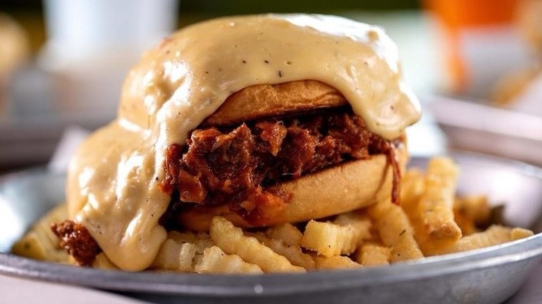 Sloppy Joe on pile of fries all covered in beer cheese at Se7en Bites in Orlando, Florida