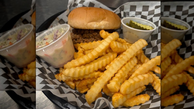 Sloppy Joe in basket with fries, pickles, and coleslaw at Sloppy Hog Burger Joint in Sevierville