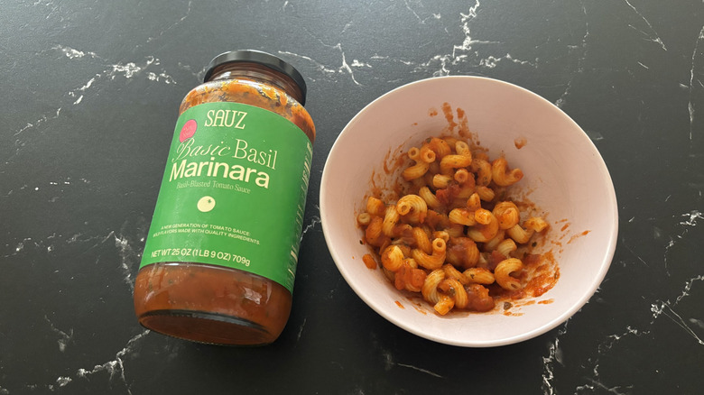 Sauz basil marinara jar next to bowl of pasta with sauce