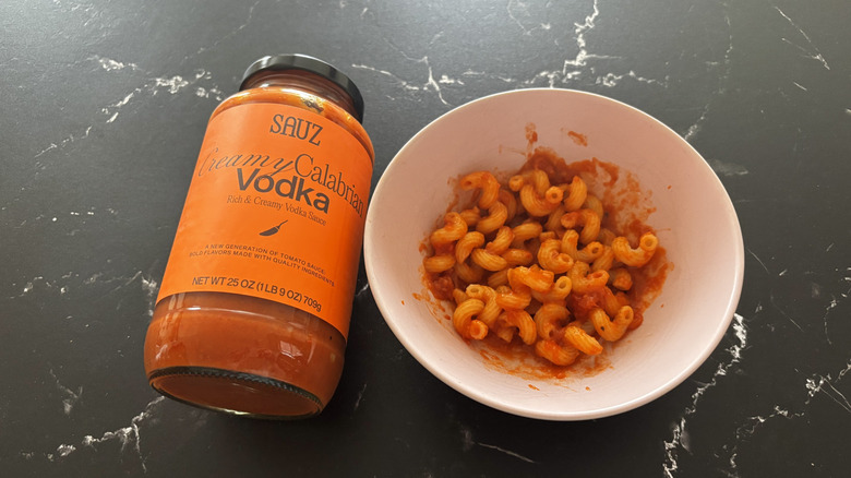 Sauz Calabrian vodka sauce jar next to pasta with sauce in bowl