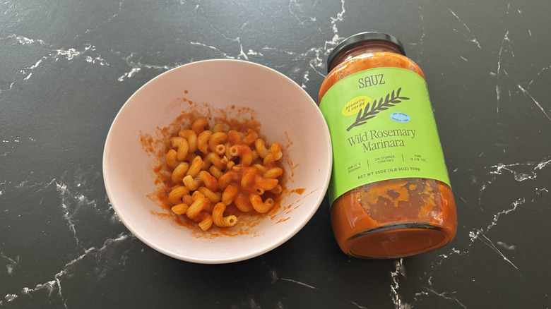Bowl of pasta with sauce next to Sauz rosemary marinara jar