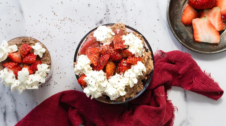 Chocolate Strawberry Brownie Trifle in glass bowl with red towel