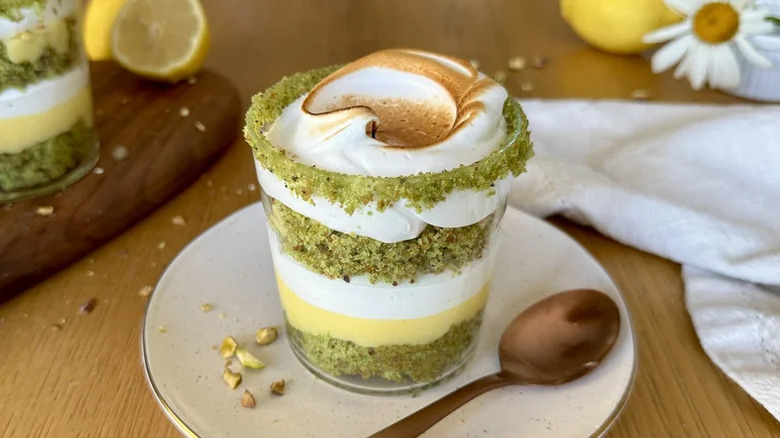 Mini Lemon Pistachio Meringue Trifles in small glass on white plate