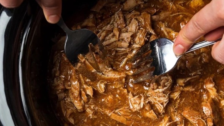 Shredding barbecued chicken in slow cooker 