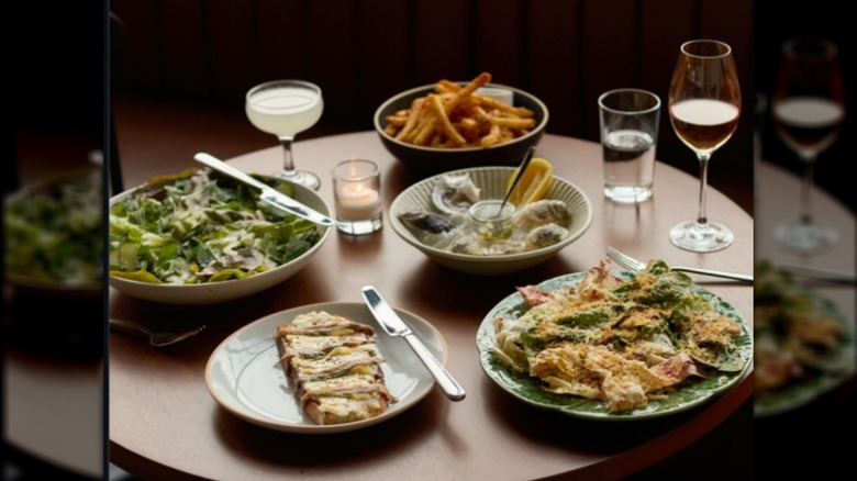 An assortment of dishes, wine, and cocktails on a table