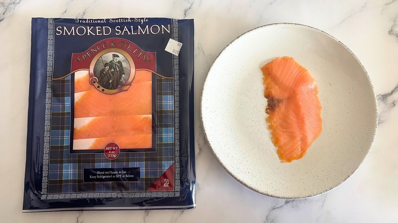 Spence & Co. smoked salmon on white plate next to packaging on white marble surface