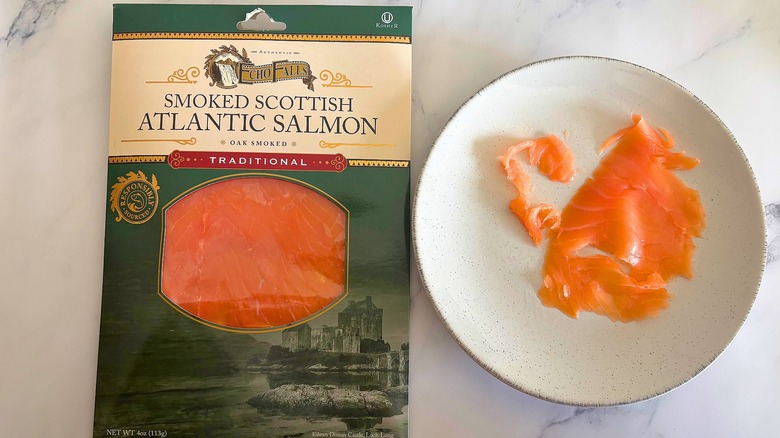 Echo Falls smoked salmon on white plate next to packaging on white marble surface