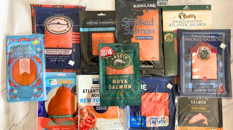 Several packages on smoked salmon on marble surface