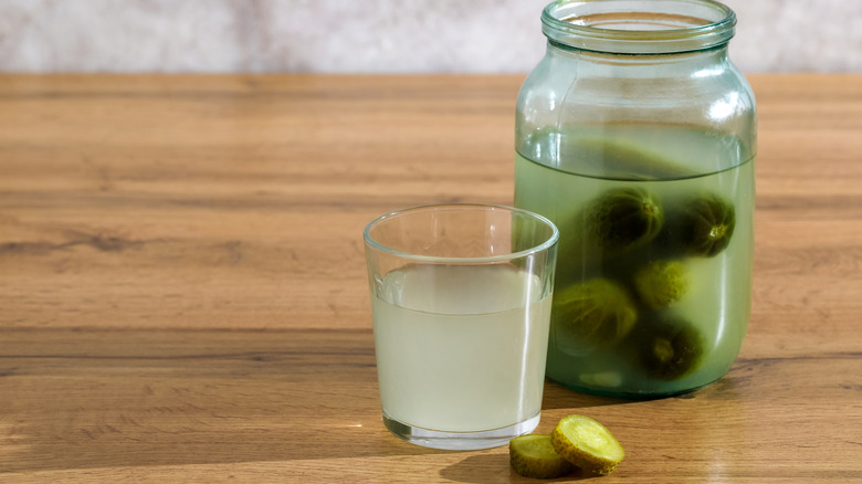 Glass and jar of pickle brine