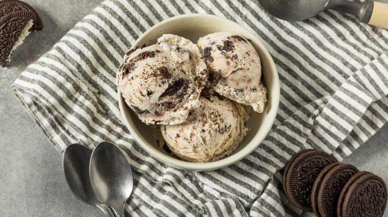 A bowl of cookies and cream ice cream with Oreo cookies