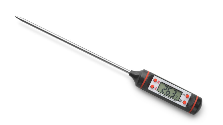 Black meat thermometer on white background