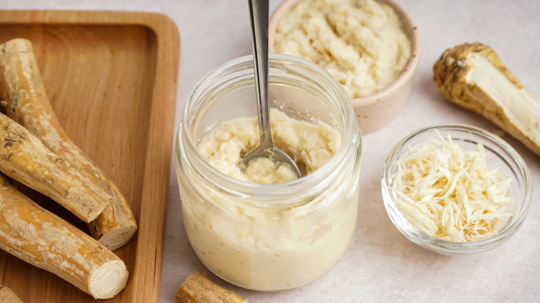Jar of horseradish with sliced horseradish roots